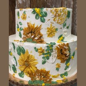 Two tier birthday cake for her covered in painted sunflowers