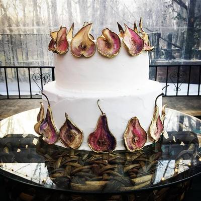 Unique wedding cake covered in gold-painted dried pears