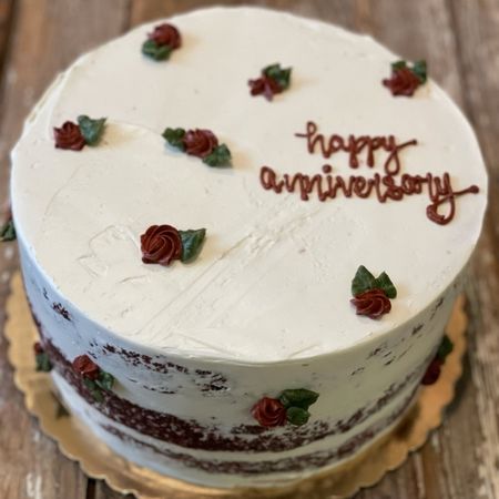 happy anniversary cake covered in small roses
