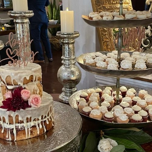 Wedding dessert table covered in cake pops and macarons
