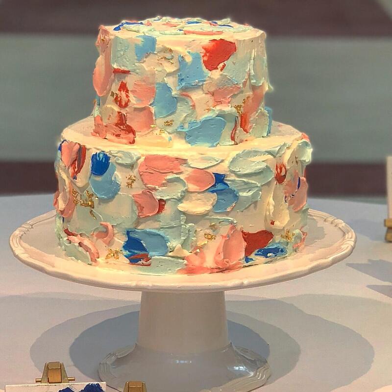 Abstract wedding cake covered in hand-painted buttercream