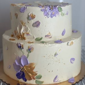 Two tier bridal shower cake covered in painted flowers