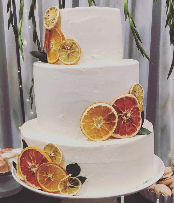 Simple, unique wedding cake decorated with orange slices